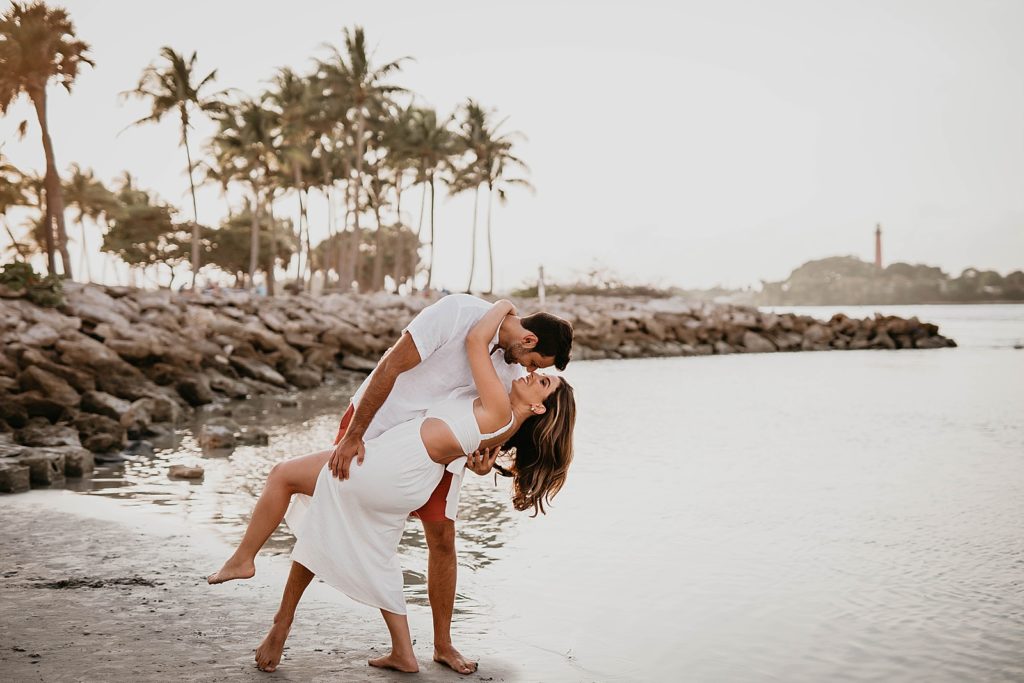 Couple dipping by the shoreline