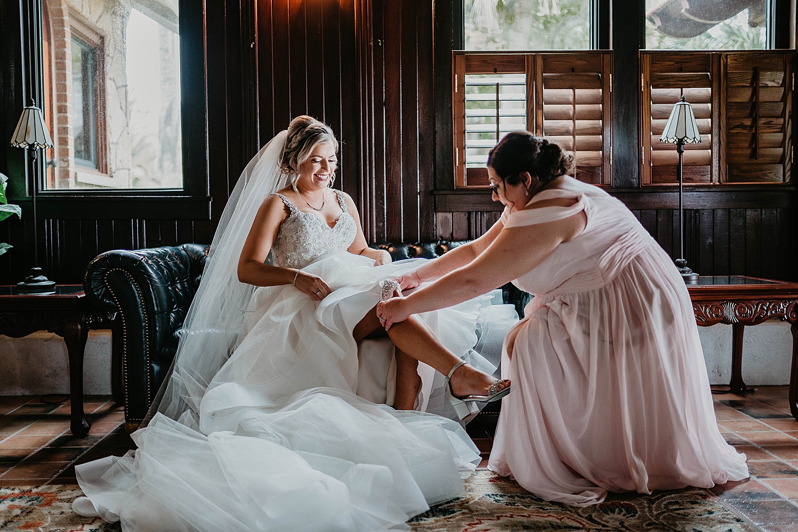 Bride getting help putting on garter