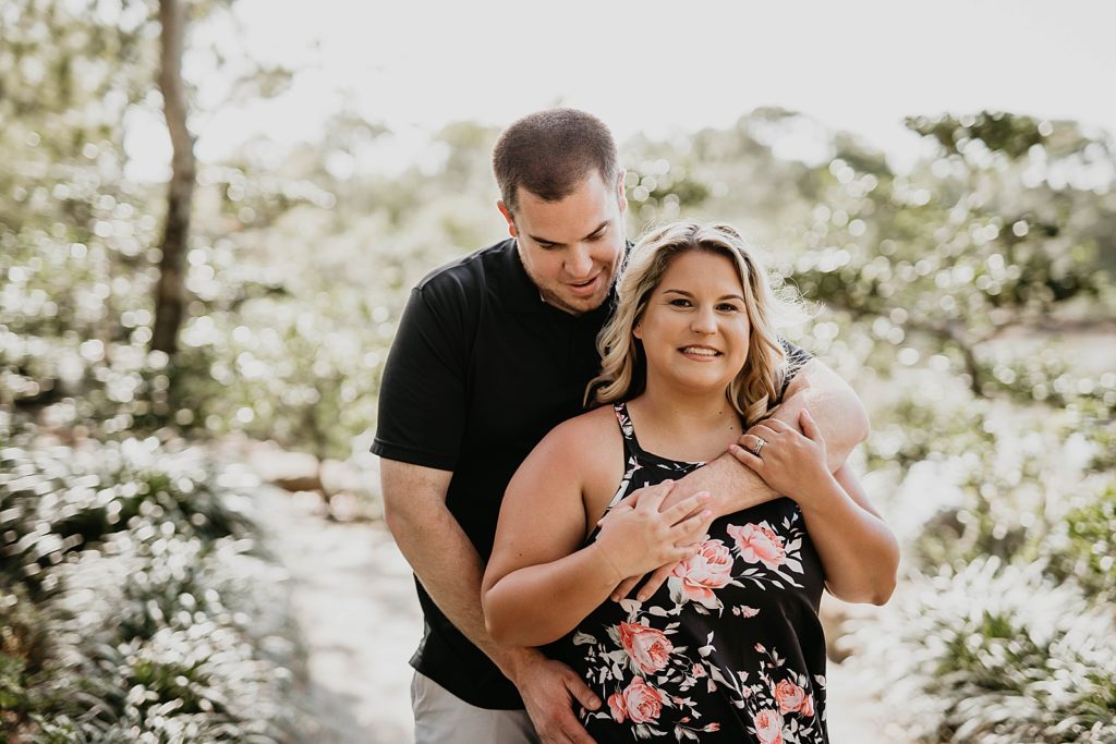 Man holding lady from behind 