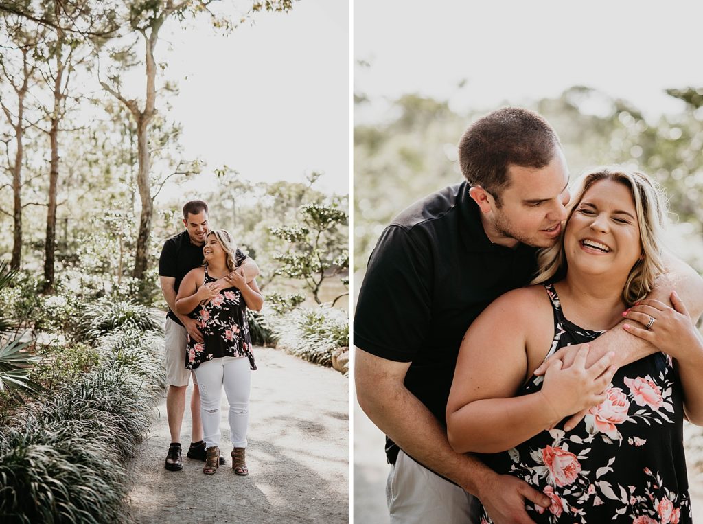 Man holding woman close from behind