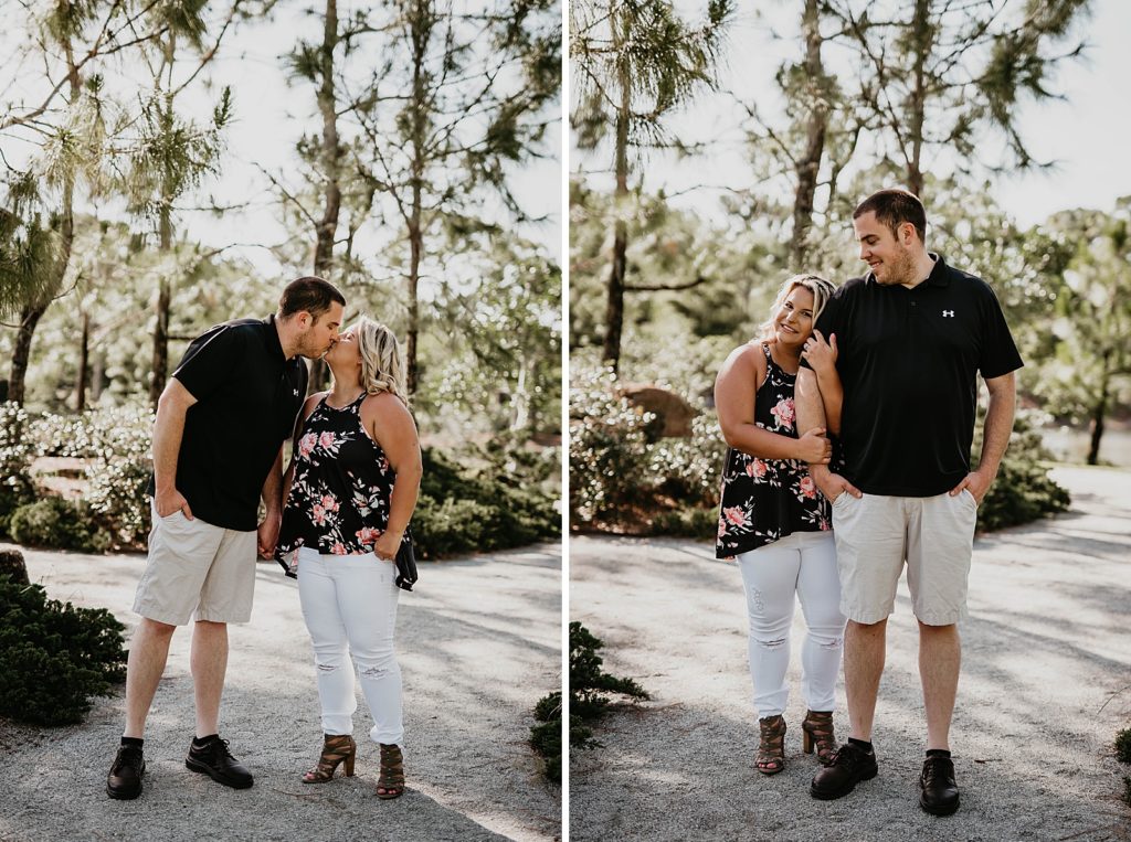 Couple kissing and holding each other close on pathway