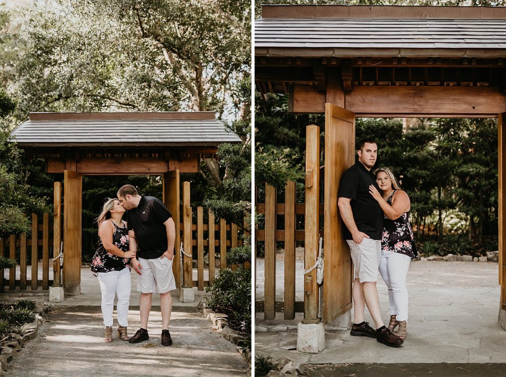 Couple kissing in front of gate entrance