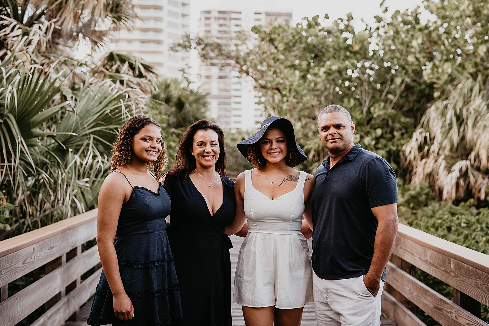 Family posing together on bridge together