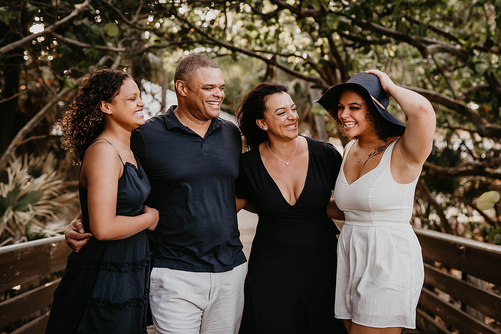 Family smiling together by greenery
