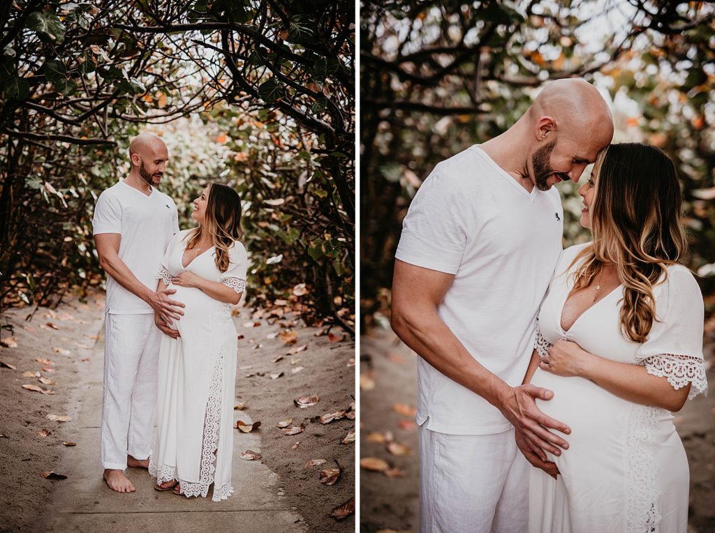 Pregnant Couple looking at each other and resting their heads on each other