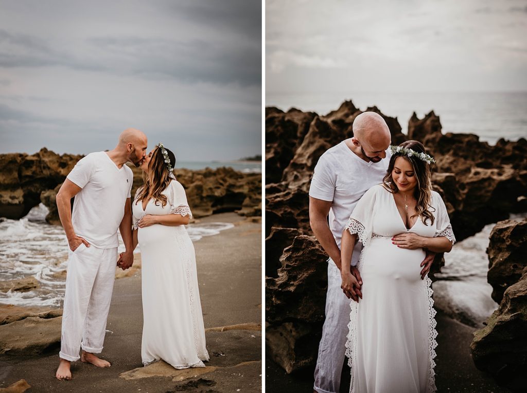 Pregnant couple kissing and maneuvering through beach rock 
