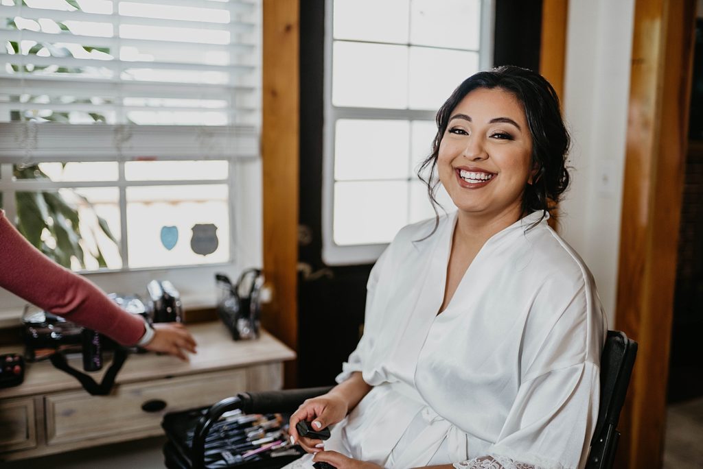 Bride getting ready with makeup artist