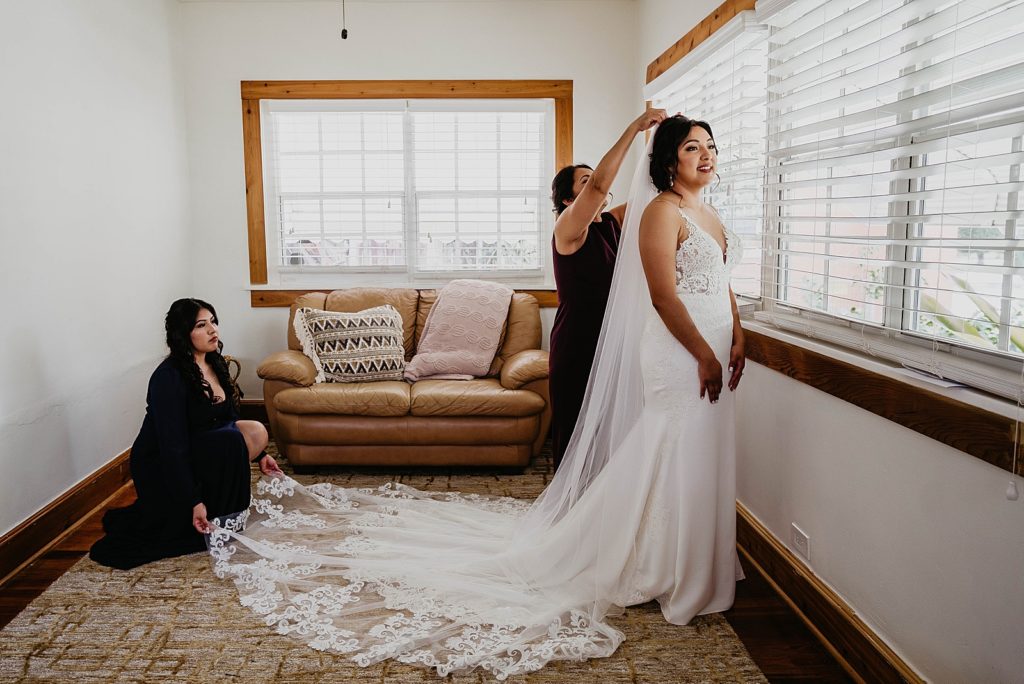 Bride putting on her veil