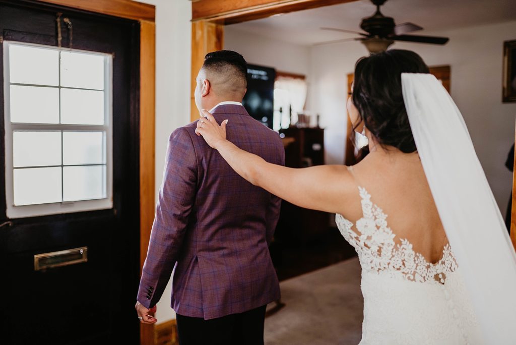 Bride tapping Groom on shoulder for first look