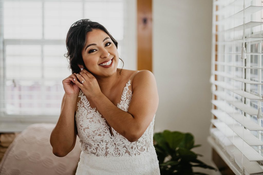 Bride getting ready putting earrings on