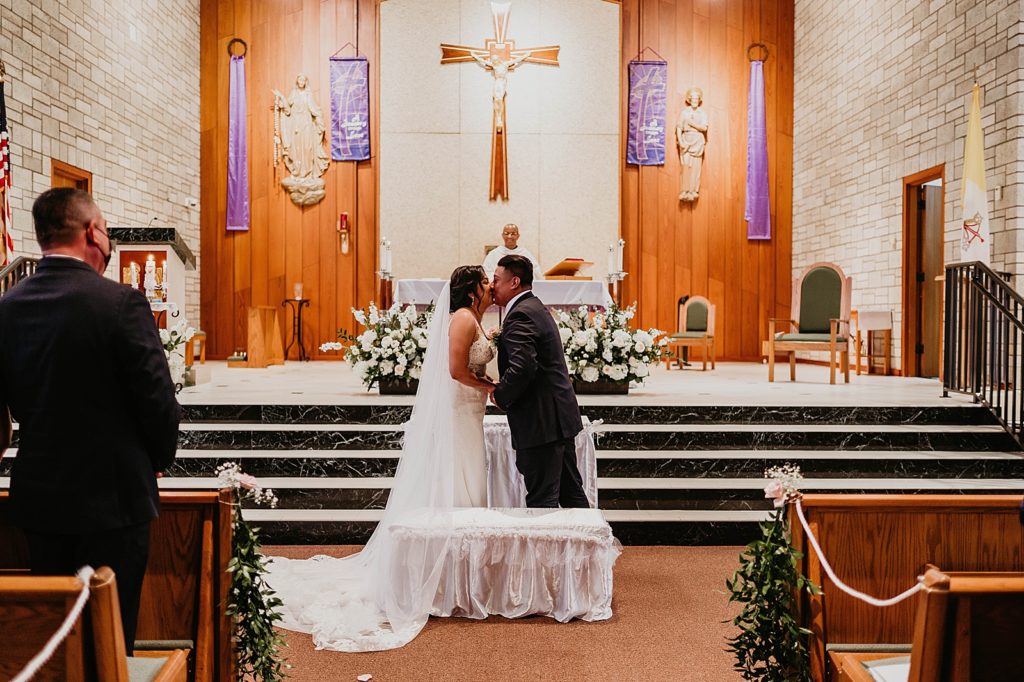 Just married Bride and Groom kissing Ceremony