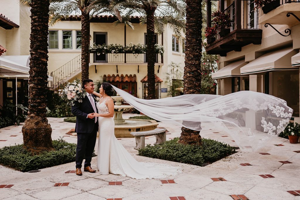 Bride in Groom in dance position with Bride's veil flowing