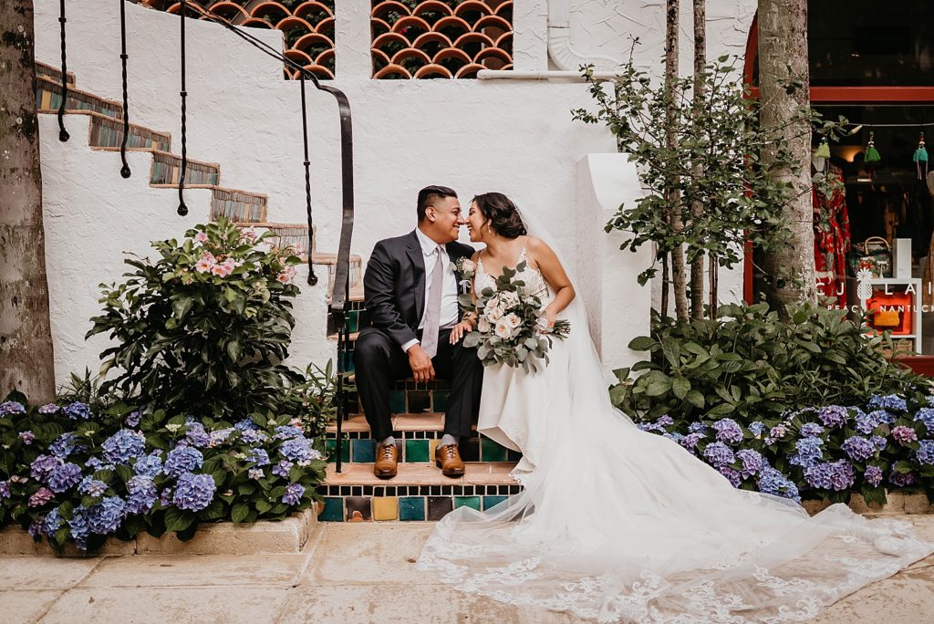 Bride and Groom sitting on stairway touching noses