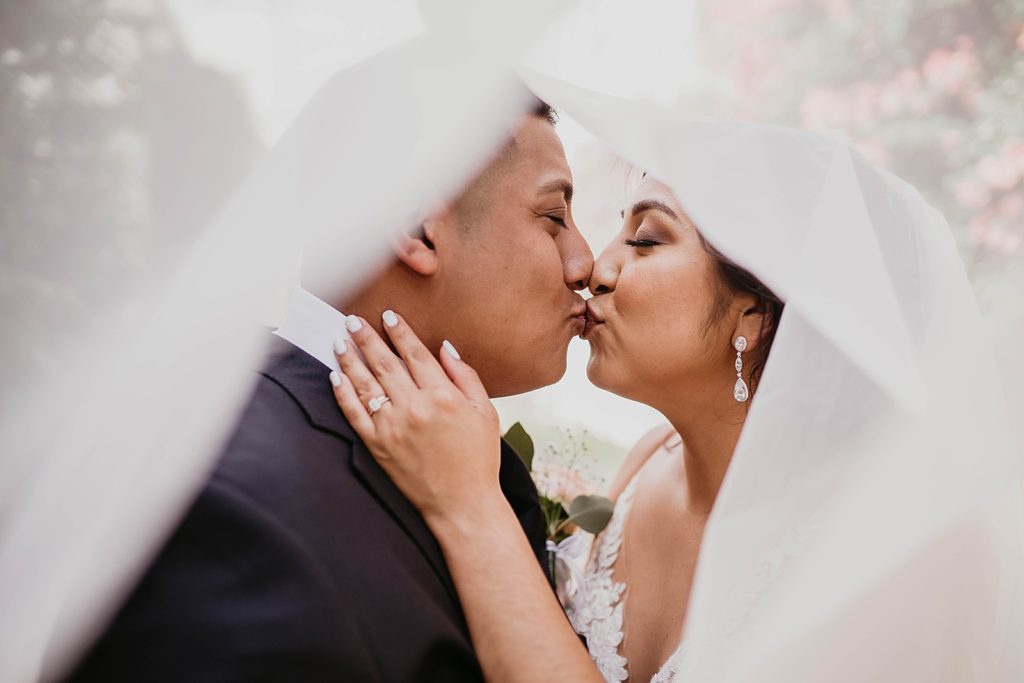 Bride and Groom kissing under the veil