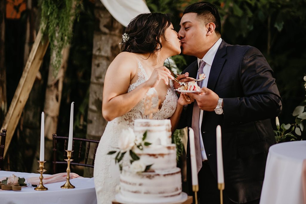 Bride and Groom kissing after cake cutting
