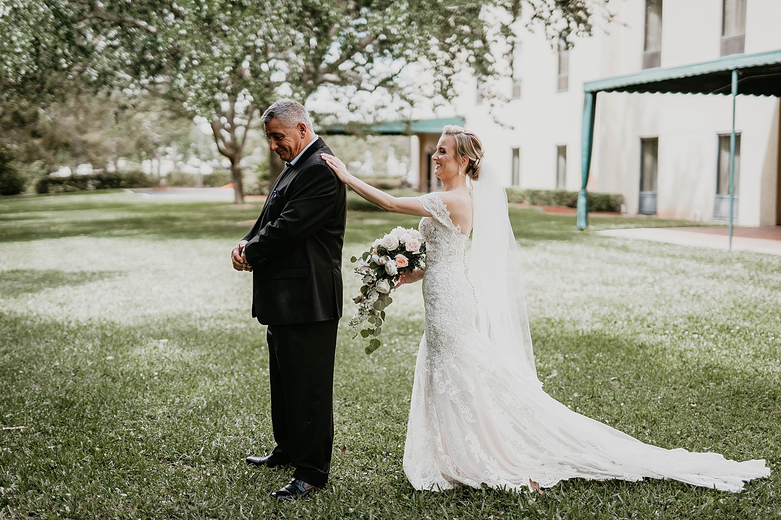 Bride tapping father on the shoulder for first look