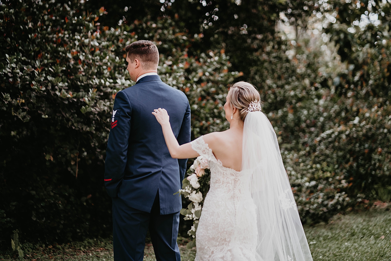 Bride about to tap Groom's shoulder for first look