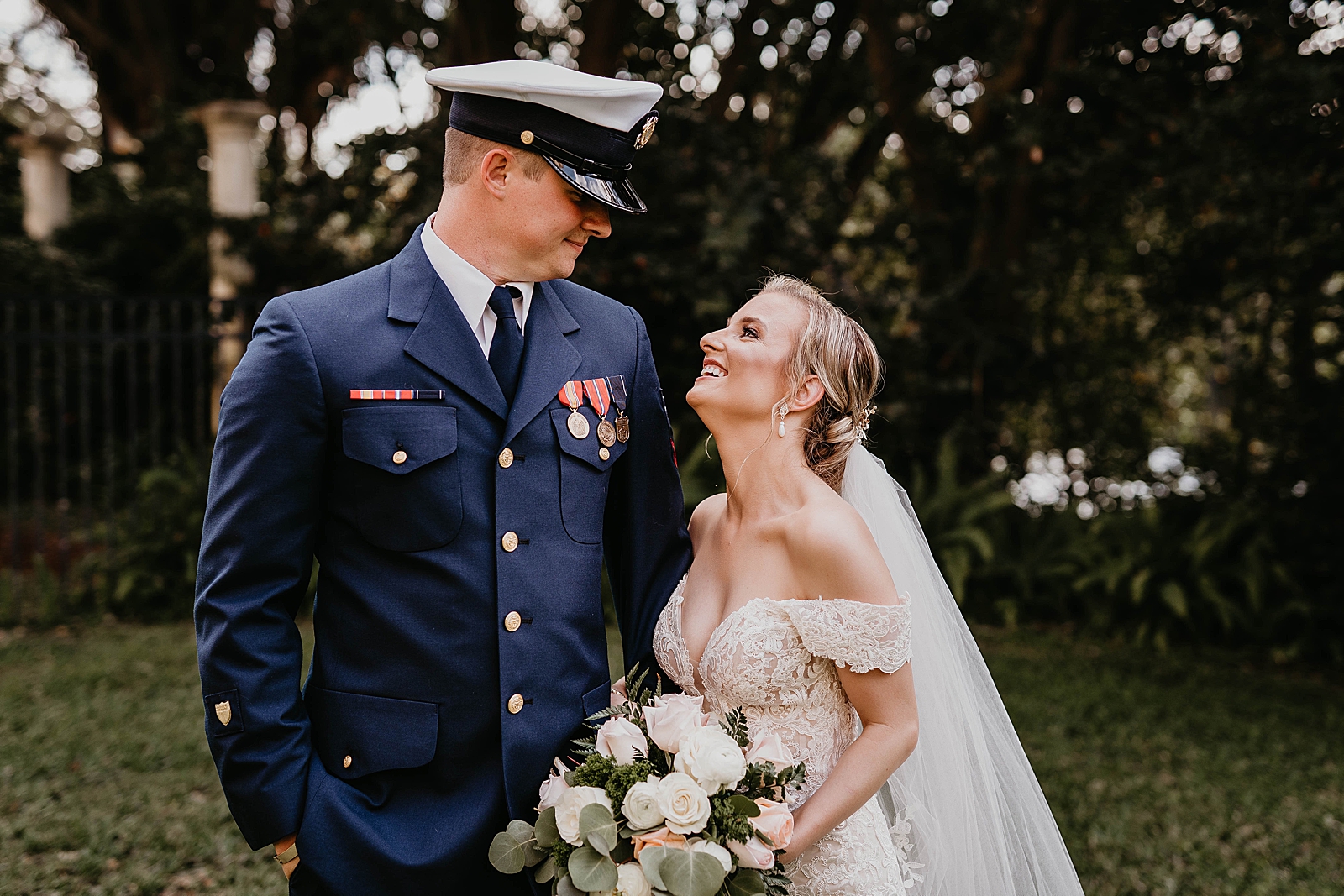Bride and Groom looking at each other with Bride holding bouquet
