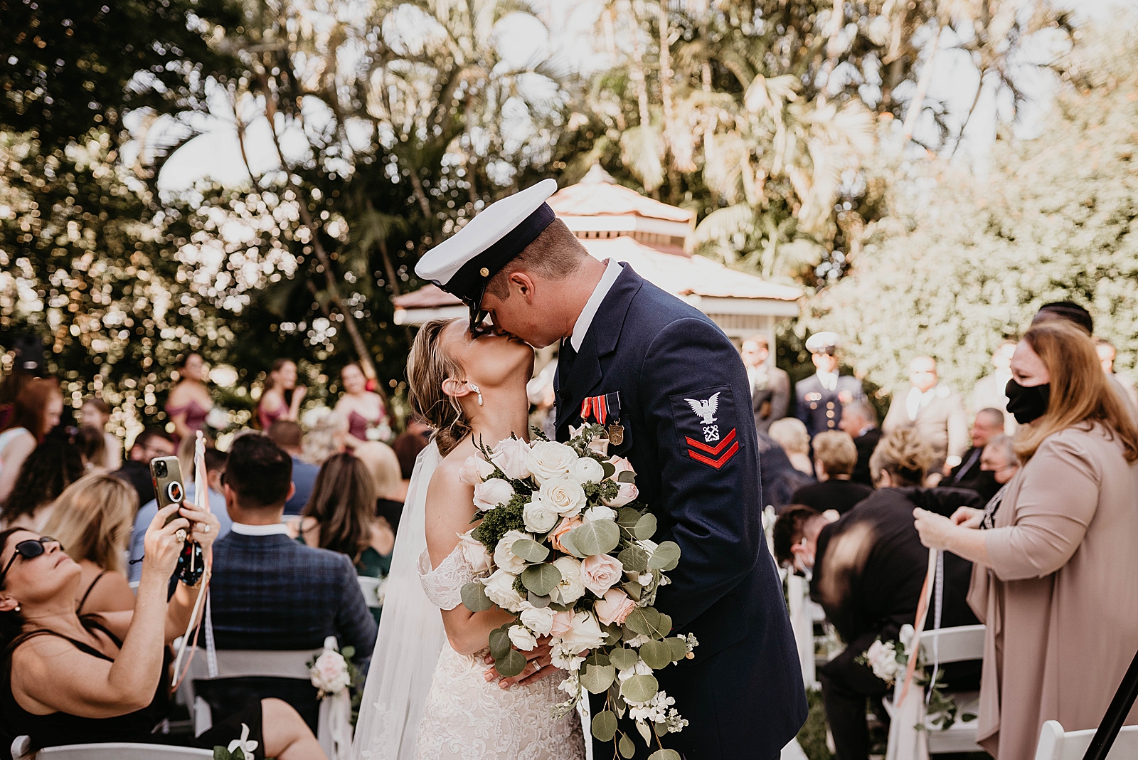 Bride and Groom kissing halfway through Ceremony exit