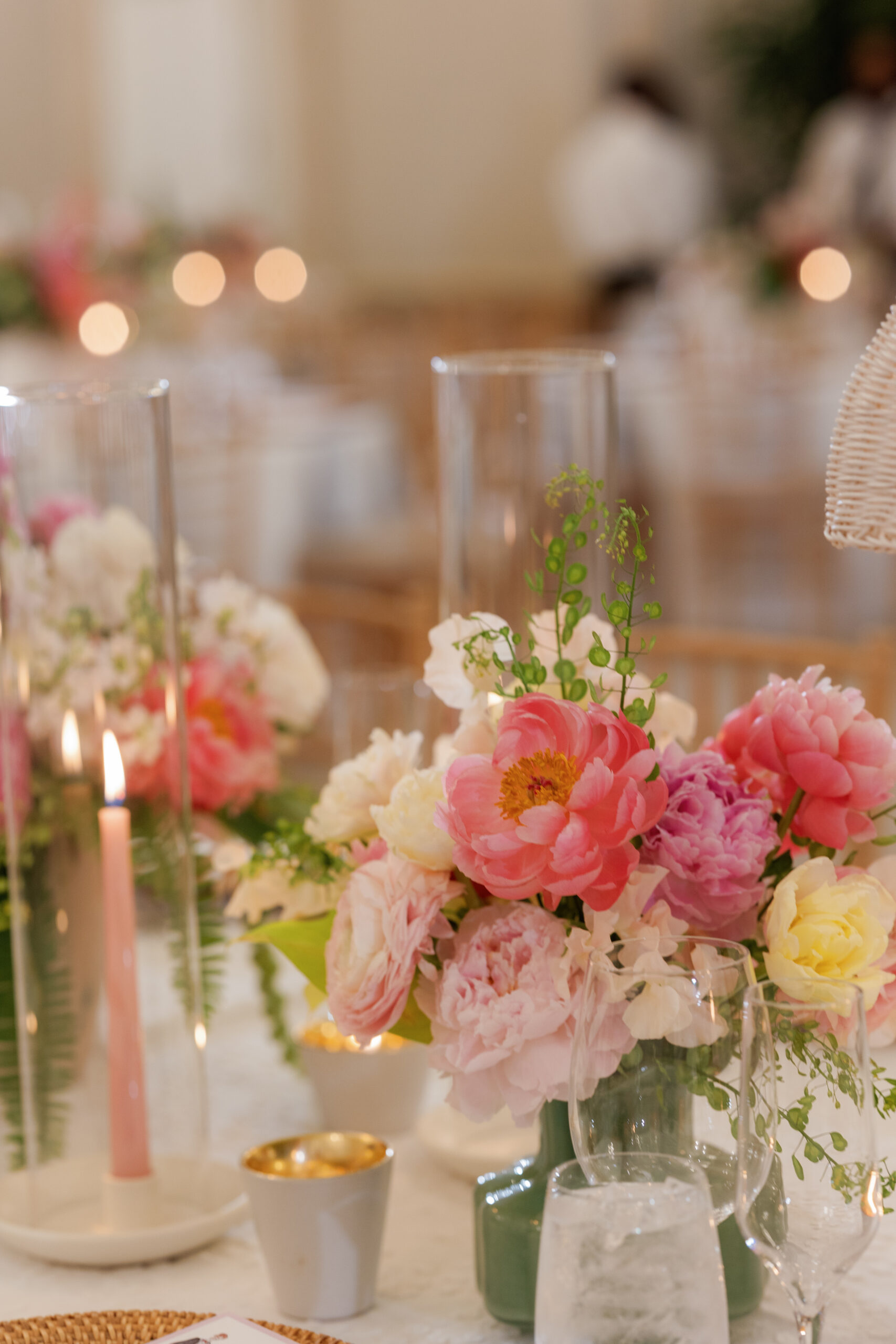 Harper and Luke wedding at The Colony Palm Beach - reception - A close-up of a wedding reception table setting with pink flowers, candles, and 