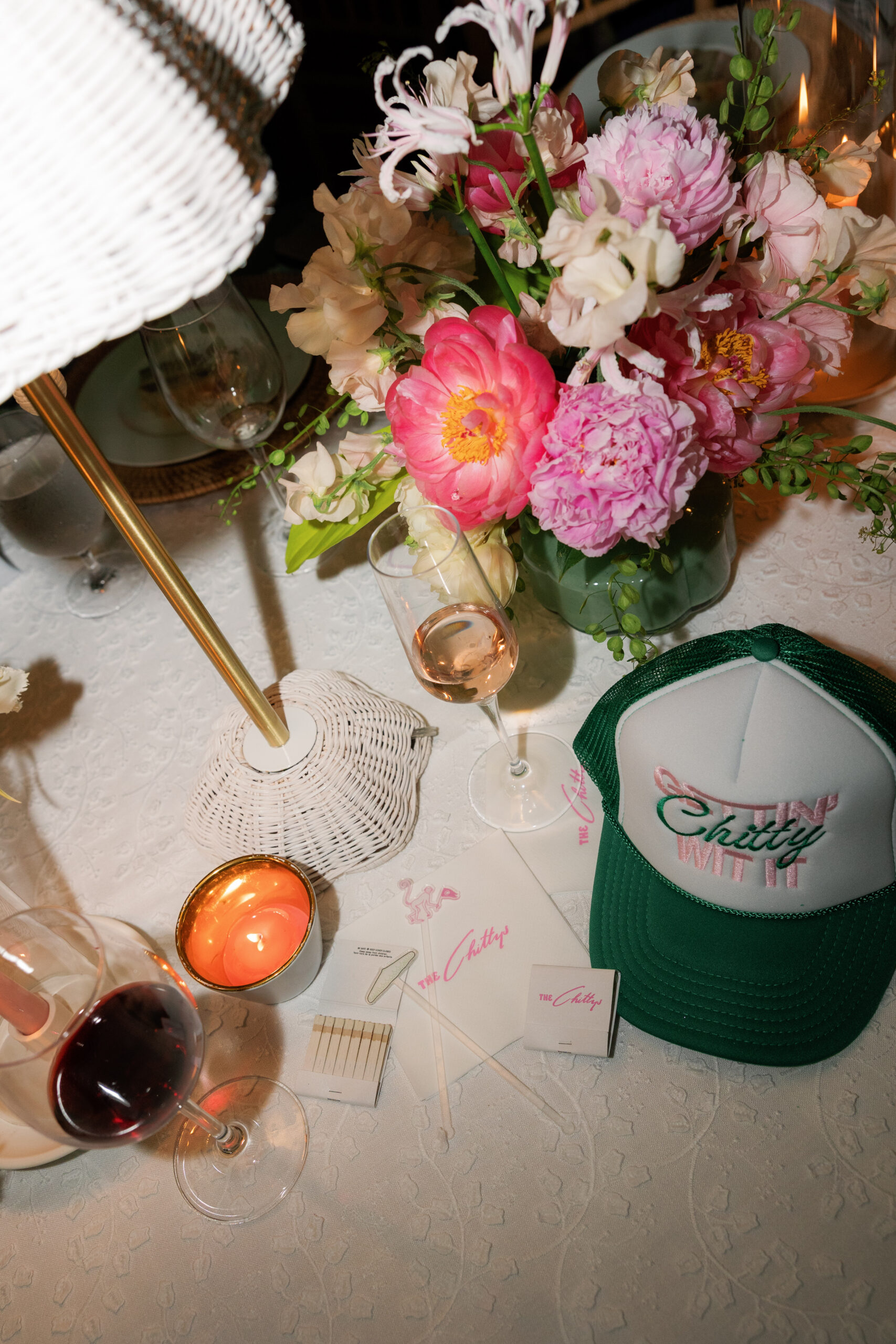 Harper and Luke wedding at The Colony Palm Beach - reception - A close-up of a wedding reception table setting with flowers, drinks, a candle, 