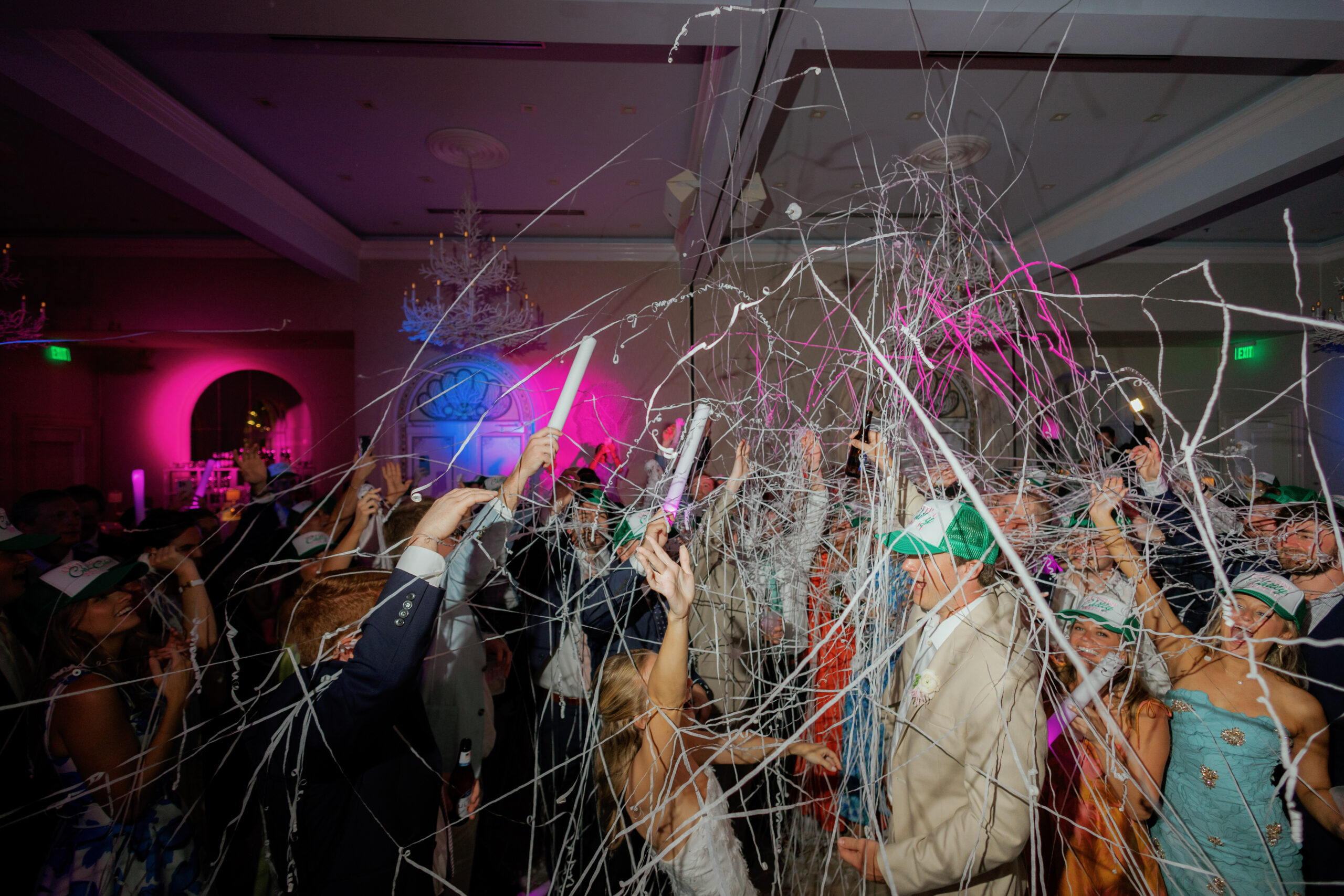 Harper and Luke wedding at The Colony Palm Beach - reception - Guests celebrate with confetti and colorful lights during the wedding reception.