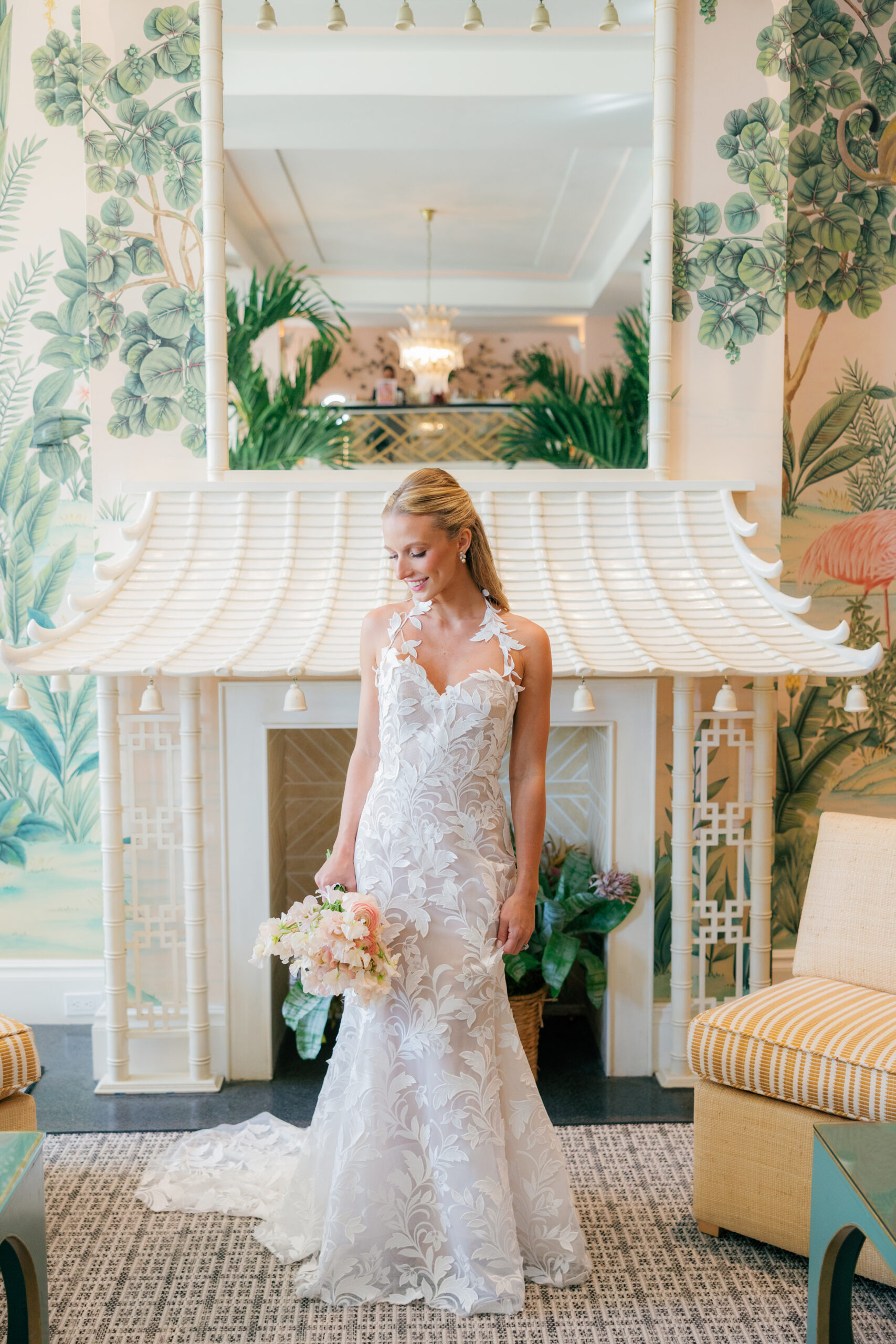 Harper and Luke wedding at The Colony Palm Beach - getting ready - A bride in a white lace wedding dress holding a bouquet, posing in a tropical-th