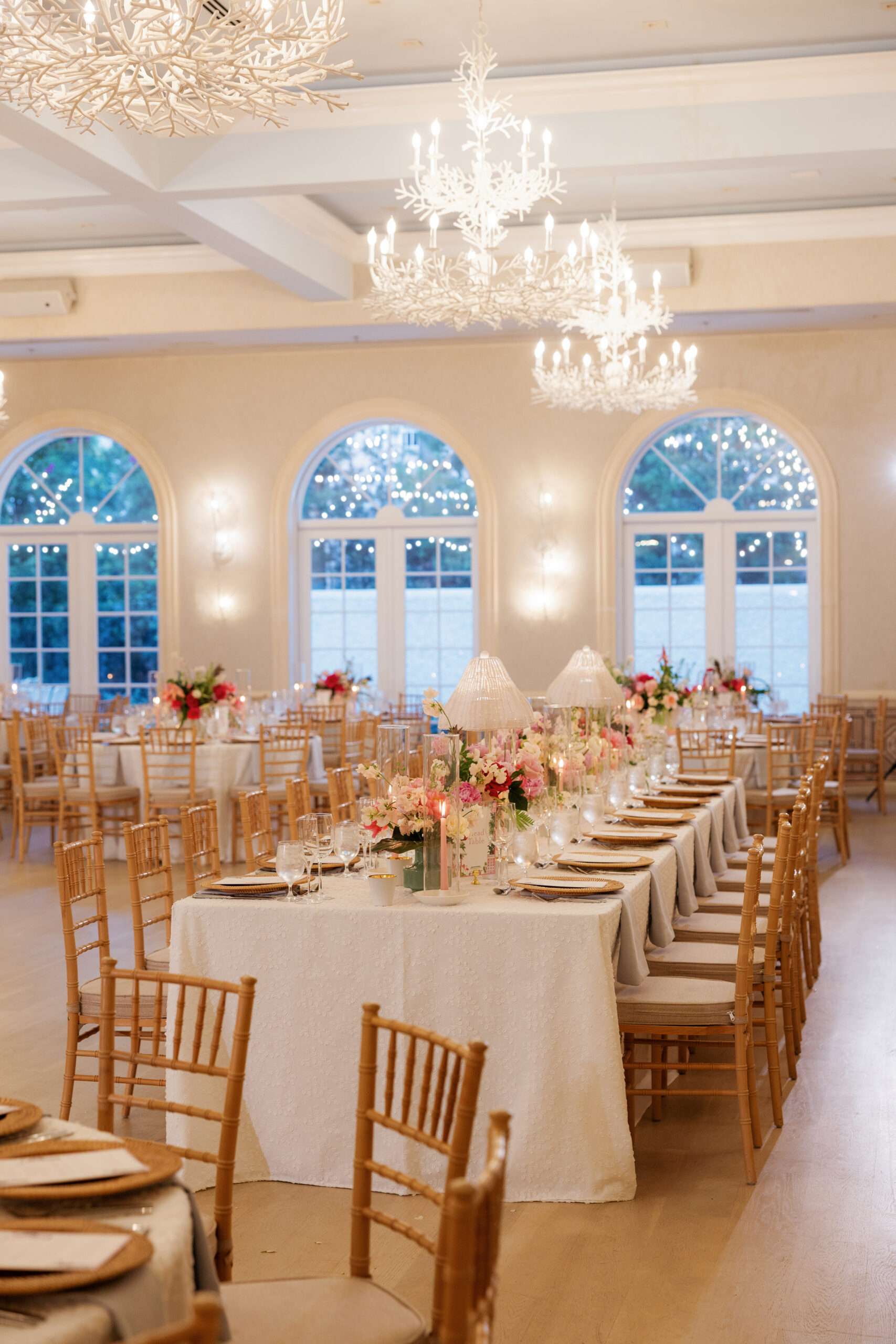 Harper and Luke wedding at The Colony Palm Beach - reception - A beautifully decorated reception hall with long tables set for dinner, featurin