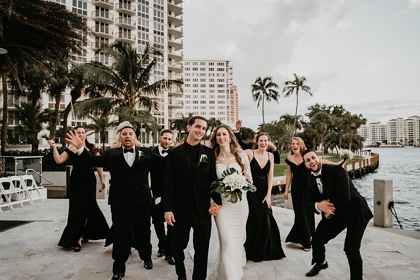 Fun walking forward pic with the whole Bridal party Waterstone Resort and Marina Wedding captured by South Florida Wedding Photographer Krystal Capone Photography