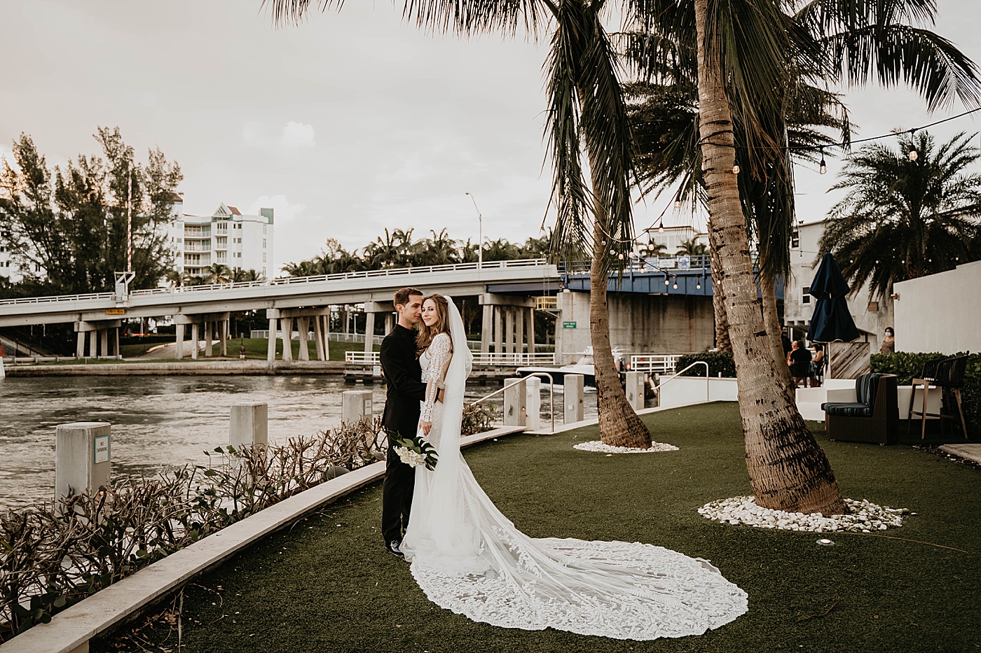 Bride and Groom holding each other Waterstone Resort and Marina Wedding captured by South Florida Wedding Photographer Krystal Capone Photography