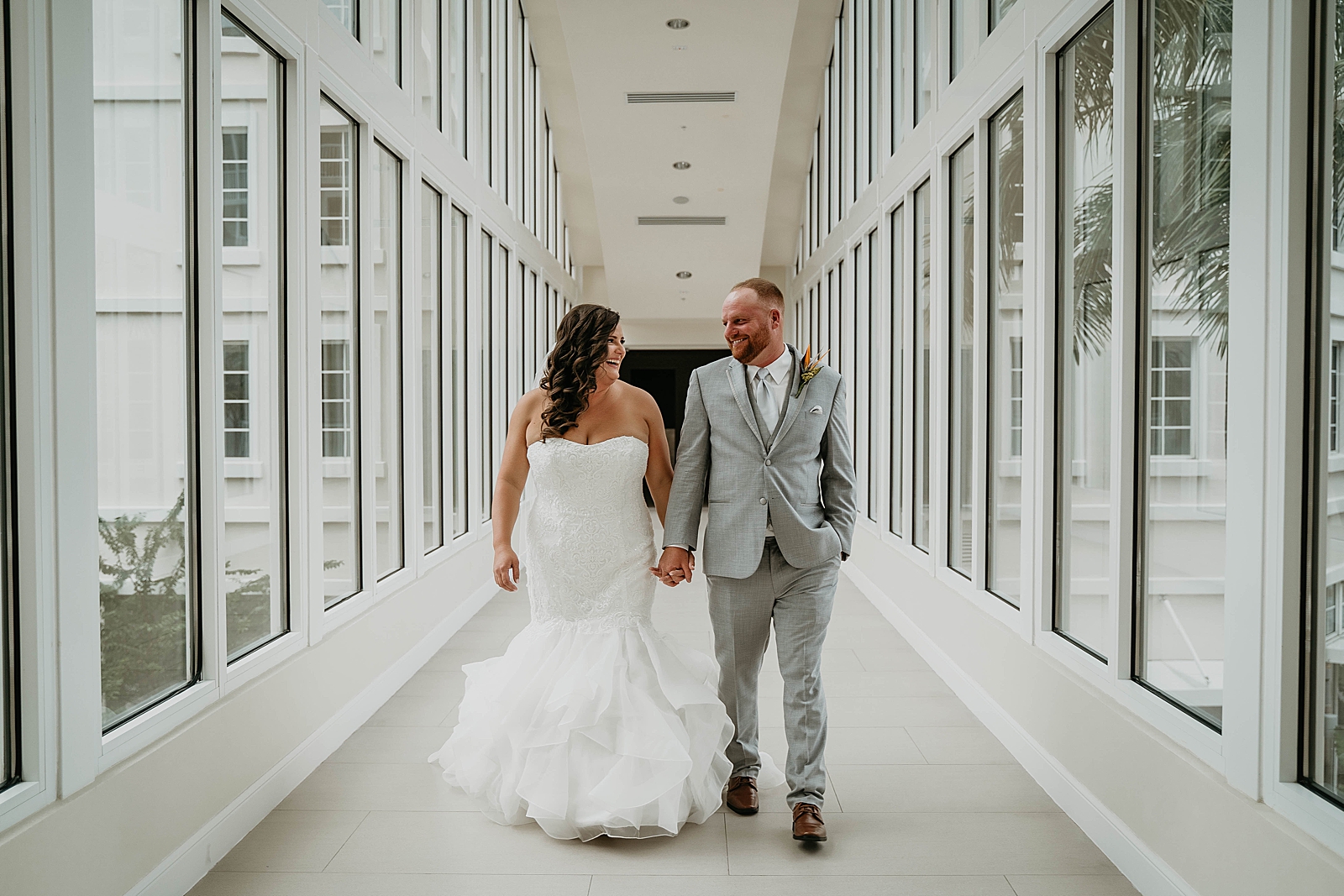Bride and Groom holding hands walking down the hallway Jupiter Lighthouse Wedding Photography captured by South Florida Wedding Photographer Krystal Capone Photography