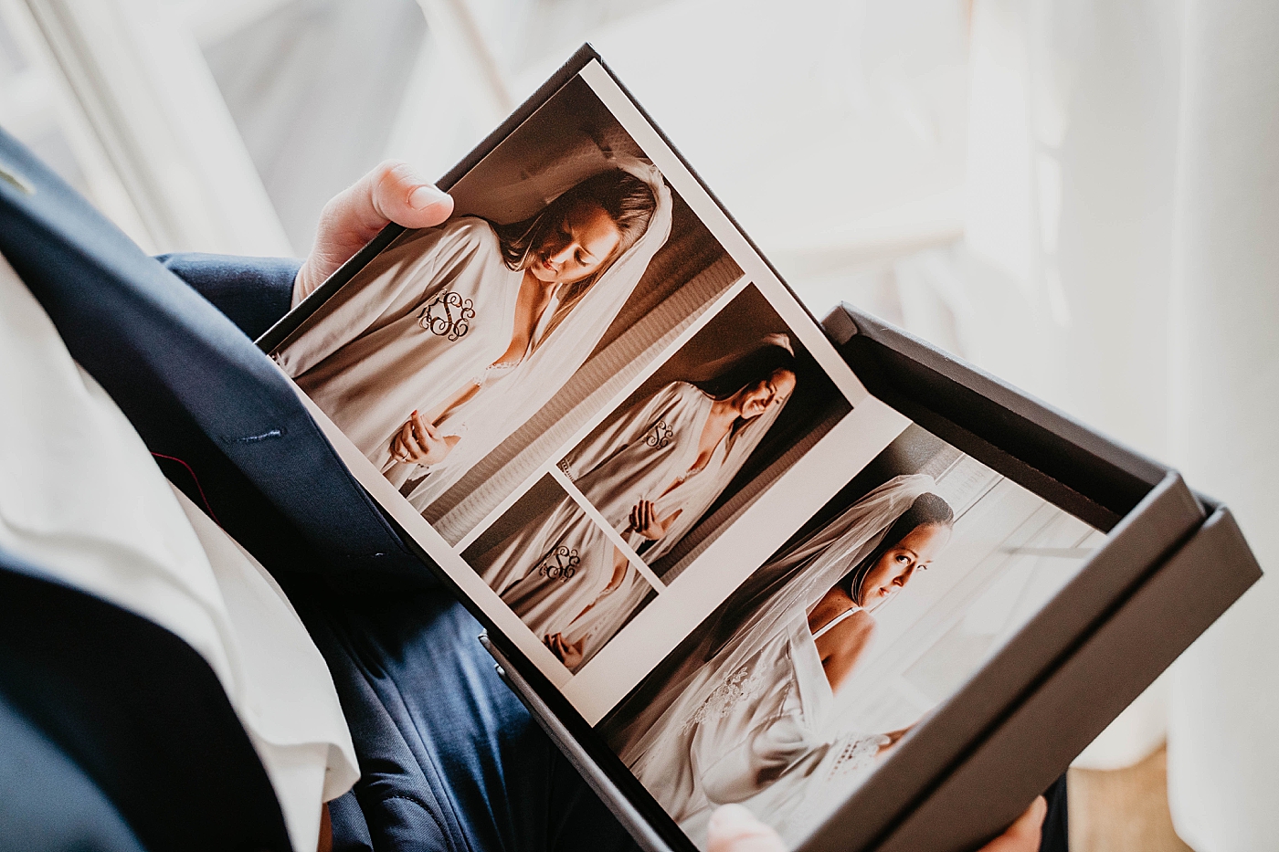 Groom looking at Brides boudoir album getting ready Out of the Blue Celebrations Wedding Photography captured by South Florida Wedding Photographer Krystal Capone Photography 