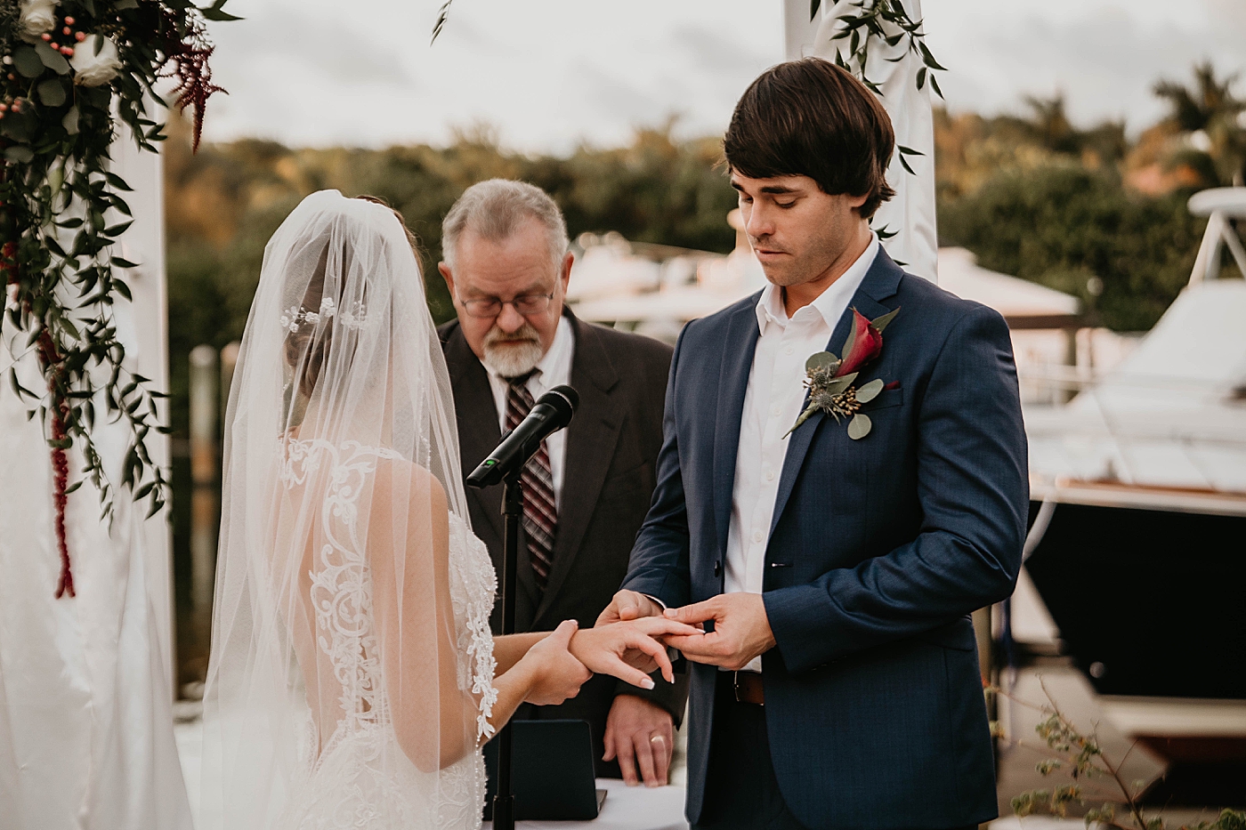 Groom putting ring on Bride for Ceremony Out of the Blue Celebrations Wedding Photography captured by South Florida Wedding Photographer Krystal Capone Photography 