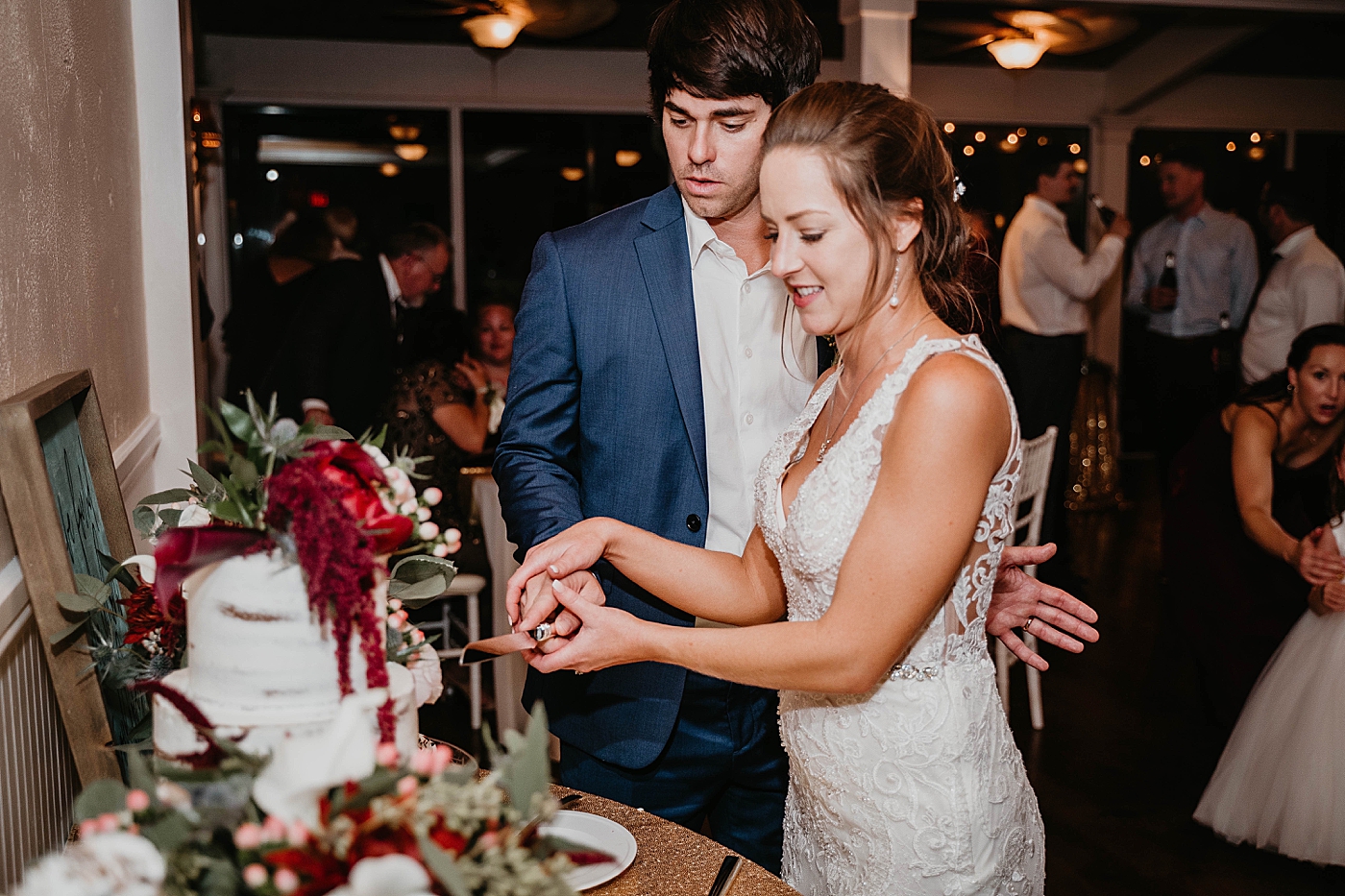 Bride and Groom cutting cake Out of the Blue Celebrations Wedding Photography captured by South Florida Wedding Photographer Krystal Capone Photography 