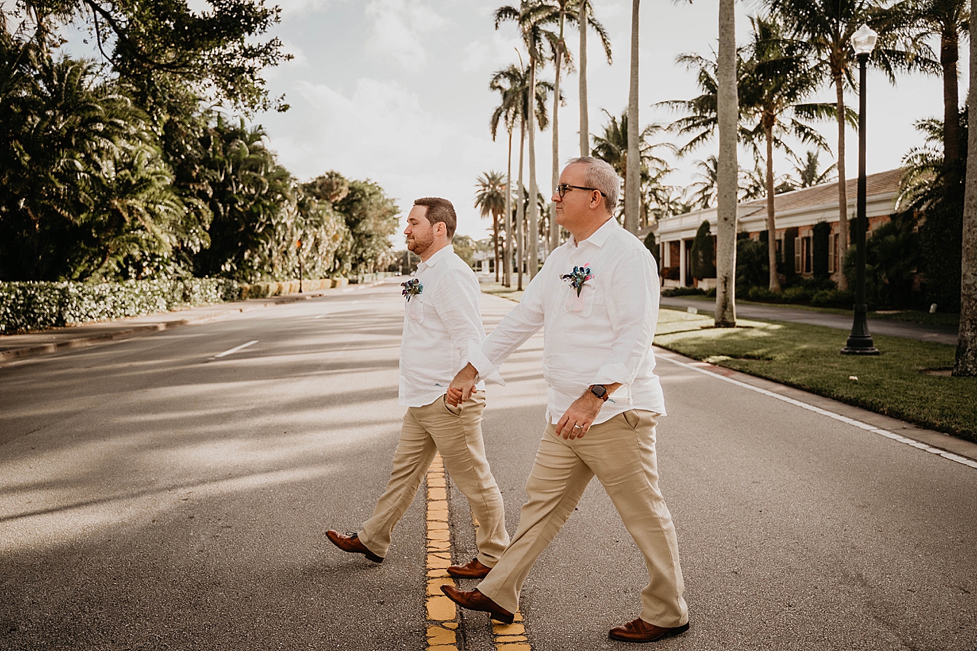 Couple holding hands and crossing the street Palm Beach Elopement Photography captured by South Florida Photographer Krystal Capone Photography 