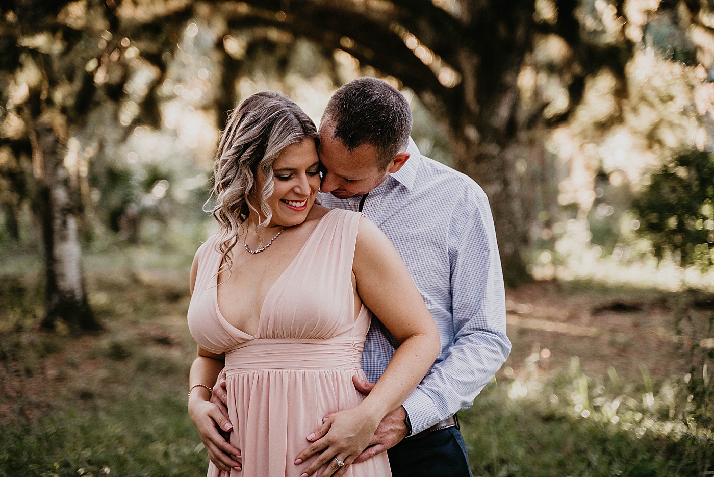 Man holding woman from behind Riverbend Park Engagement Photography captured by South Florida Engagement Photographer Krystal Capone Photography