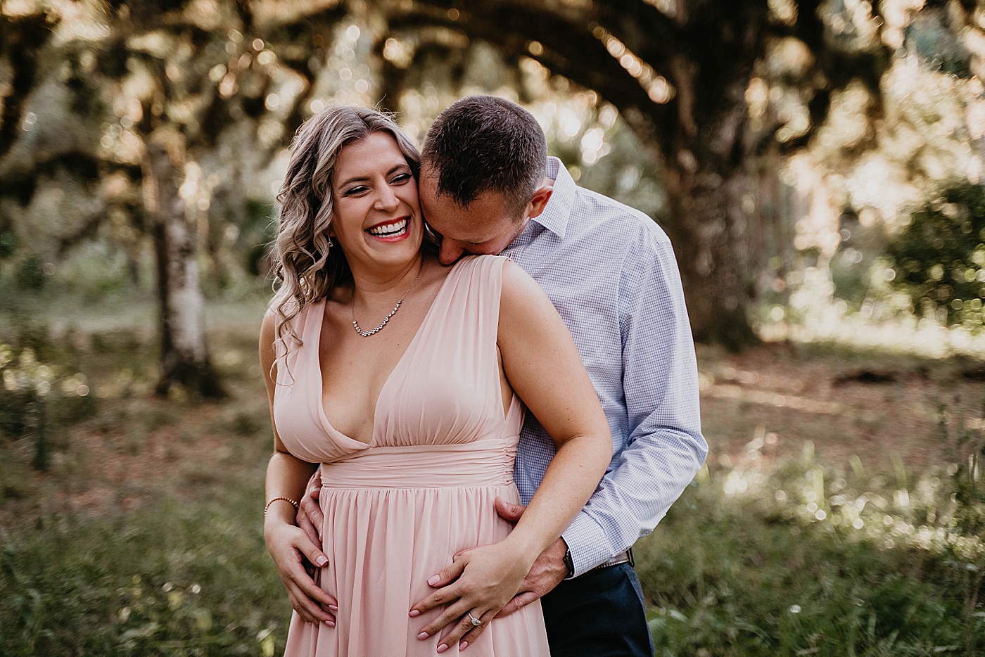 Man holding woman from behind Riverbend Park Engagement Photography captured by South Florida Engagement Photographer Krystal Capone Photography
