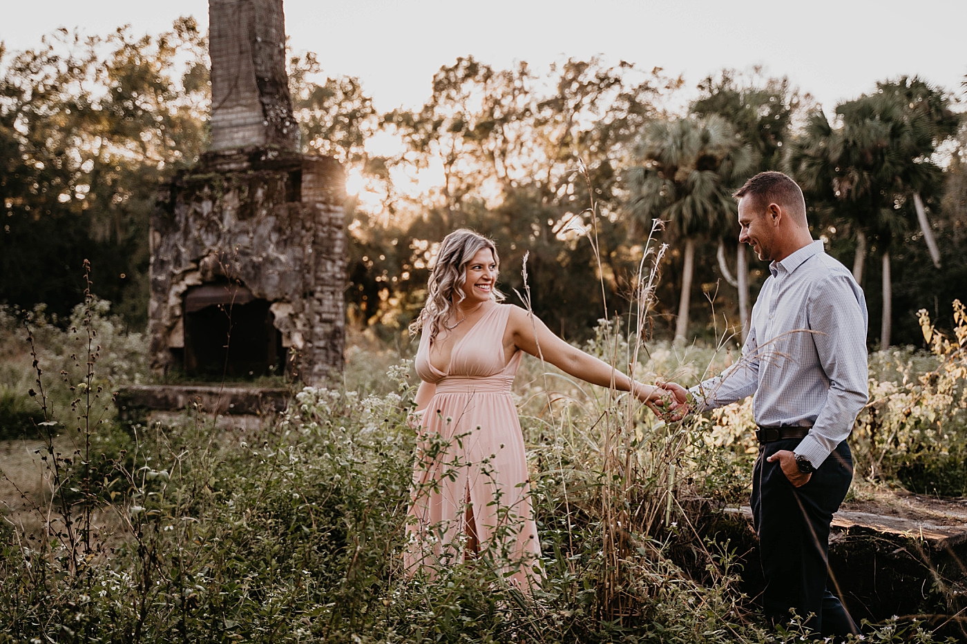 Woman leading man through park Riverbend Park Engagement Photography captured by South Florida Engagement 
