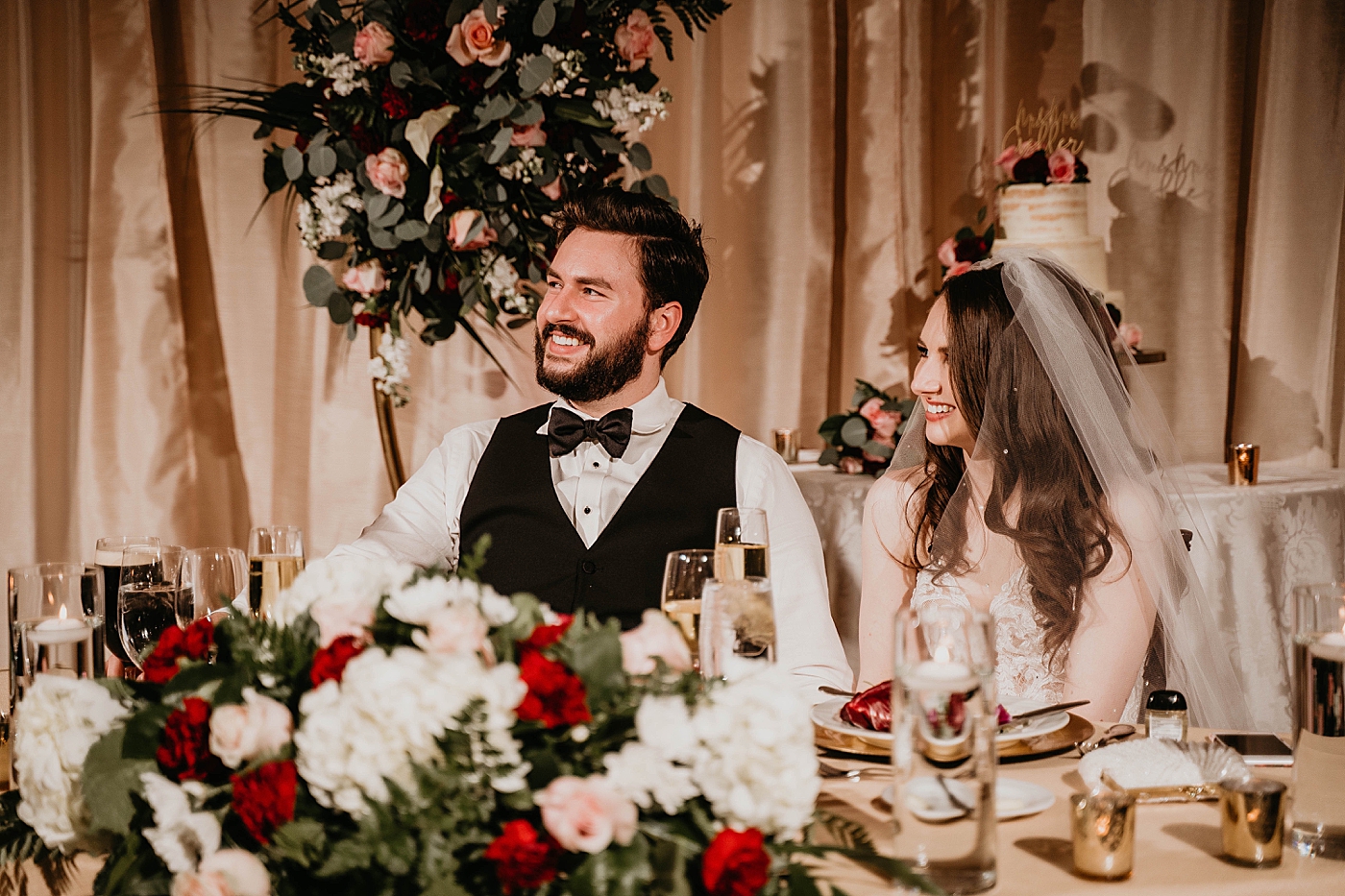 Bride and Groom listening to speeches at sweetheart table Breakers West Wedding Photography captured by South Florida Wedding Photographer Krystal Capone Photography 