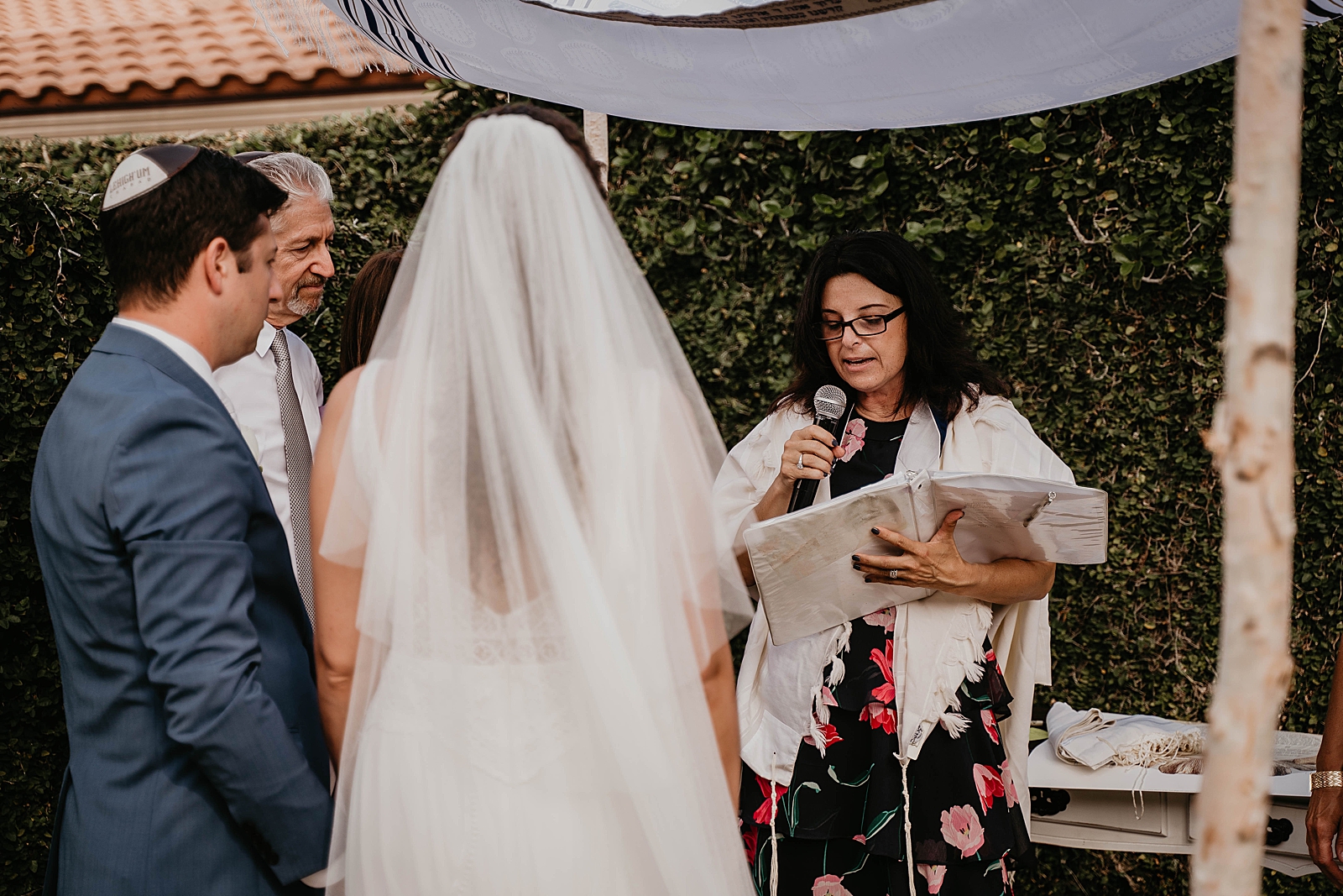 Bride and Groom listening to Officient Intimate South Florida Wedding Photography captured by South Florida Wedding Photographer Krystal Capone Photography 