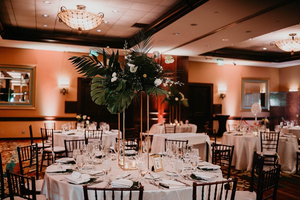 Reception detail shot of tropical palm leafs centerpiece Jupiter Beach Resort Wedding Photography captured by South Florida Wedding Photographer Krystal Capone Photography 