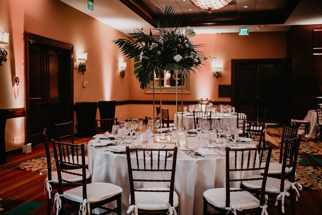 Reception Table detail shot of tropical centerpiece and black chairs with white cushions Jupiter Beach Resort Wedding Photography captured by South Florida Wedding Photographer Krystal Capone Photography 