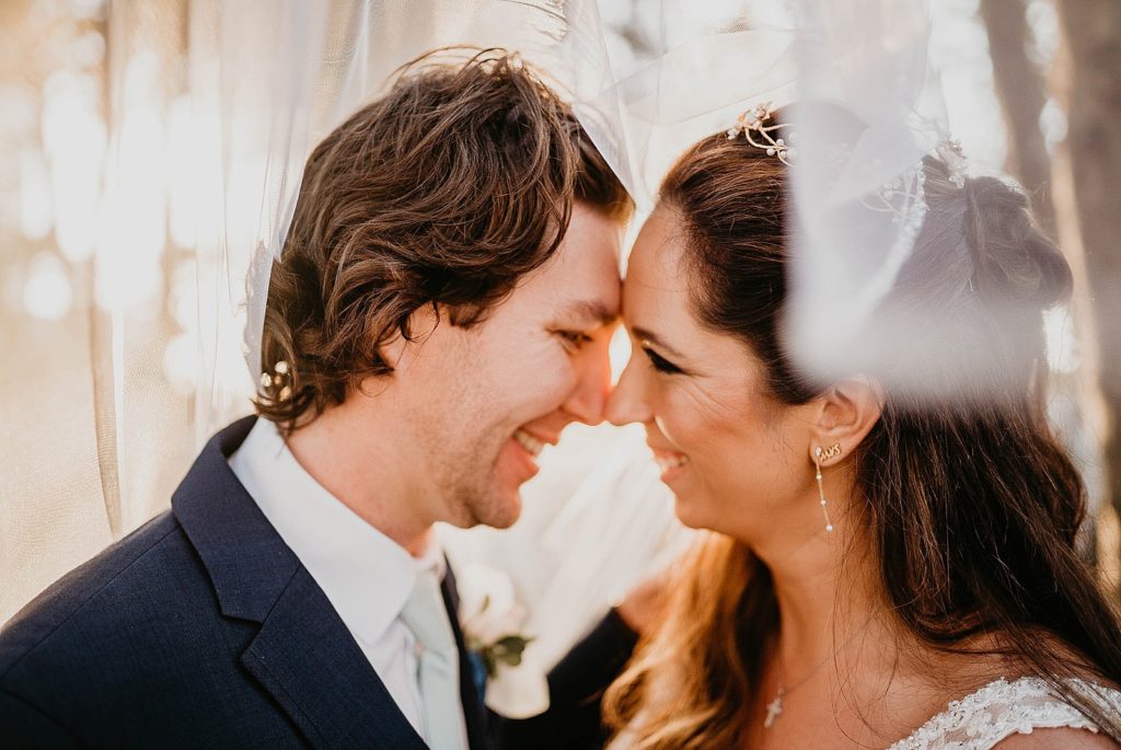 Bride and Groom nuzzling under the veil Jupiter Beach Resort Wedding Photography captured by South Florida Wedding Photographer Krystal Capone Photography 