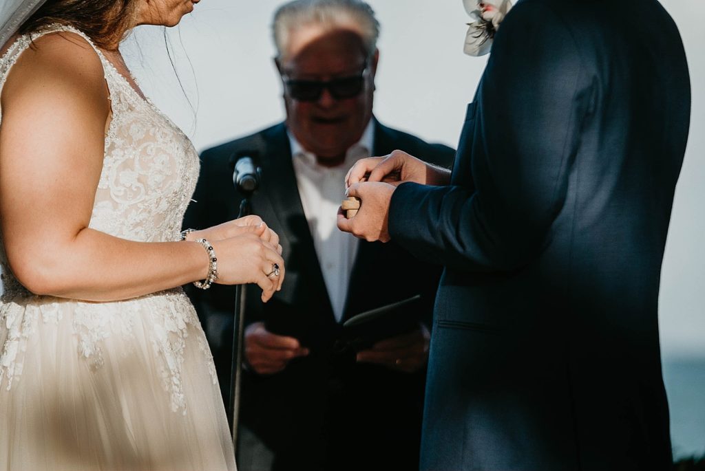 Groom grabbing wedding band during ceremony Jupiter Beach Resort Wedding Photography captured by South Florida Wedding Photographer Krystal Capone Photography 