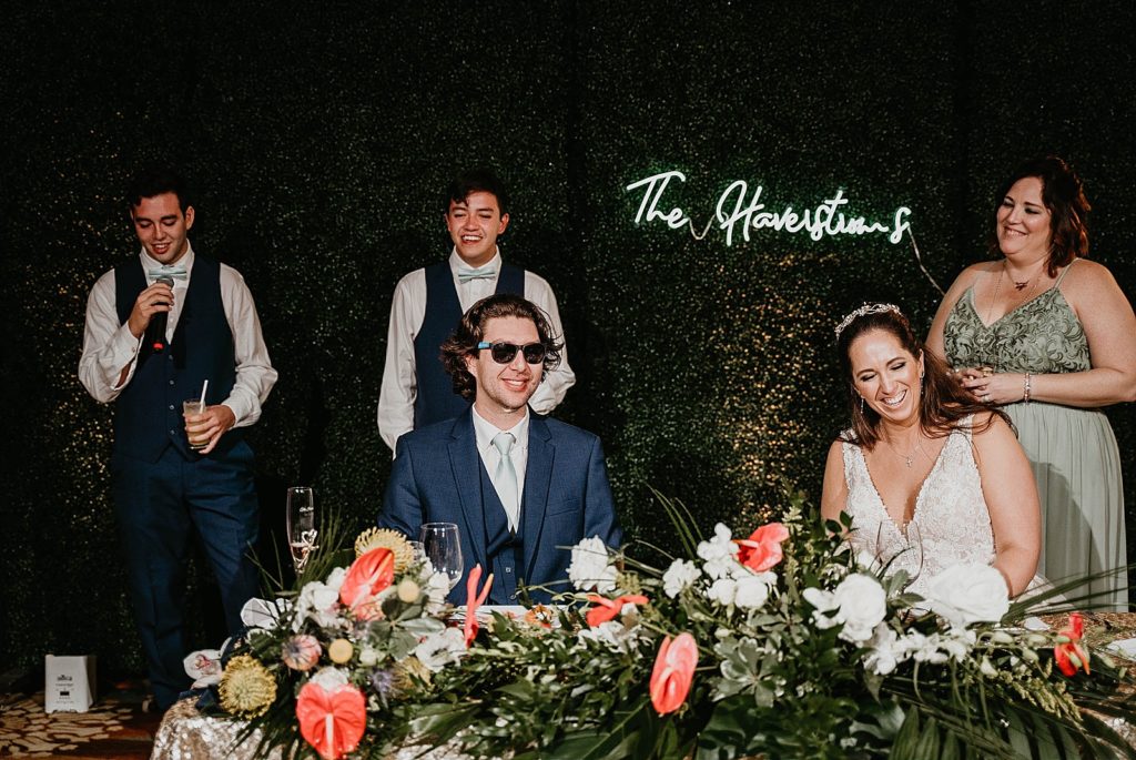 Bride and Groom having fun during speeches Jupiter Beach Resort Wedding Photography captured by South Florida Wedding Photographer Krystal Capone Photography 