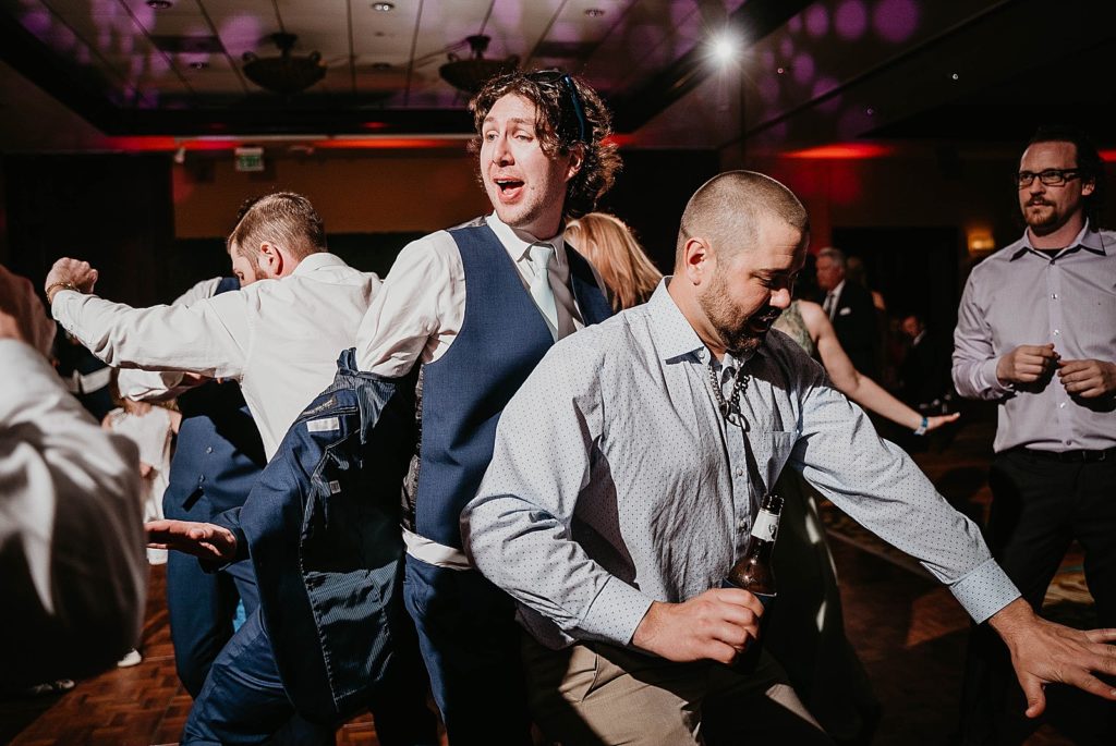 Groom dancing taking off jacket at Reception Jupiter Beach Resort Wedding Photography captured by South Florida Wedding Photographer Krystal Capone Photography 