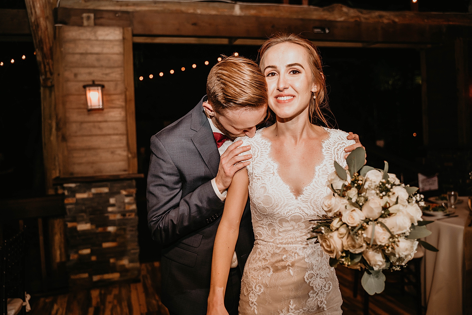Groom kissing Bride on the shoulder as they enter Reception Living Sculptures Sanctuary Wedding Photography captured by South Florida Wedding Photographer Krystal Capone Photography 