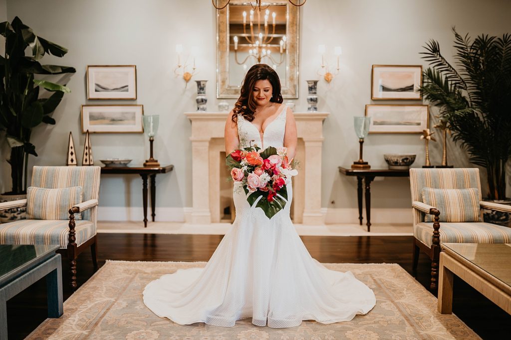 Bride fully ready holding red tropical bouquet Pelican Club Wedding Photography captured by South Florida Wedding Photographer Krystal Capone Photography 