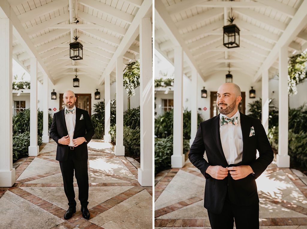 Portraits of Groom buttoning jacket outside under breezeway Pelican Club Wedding Photography captured by South Florida Wedding Photographer Krystal Capone Photography 