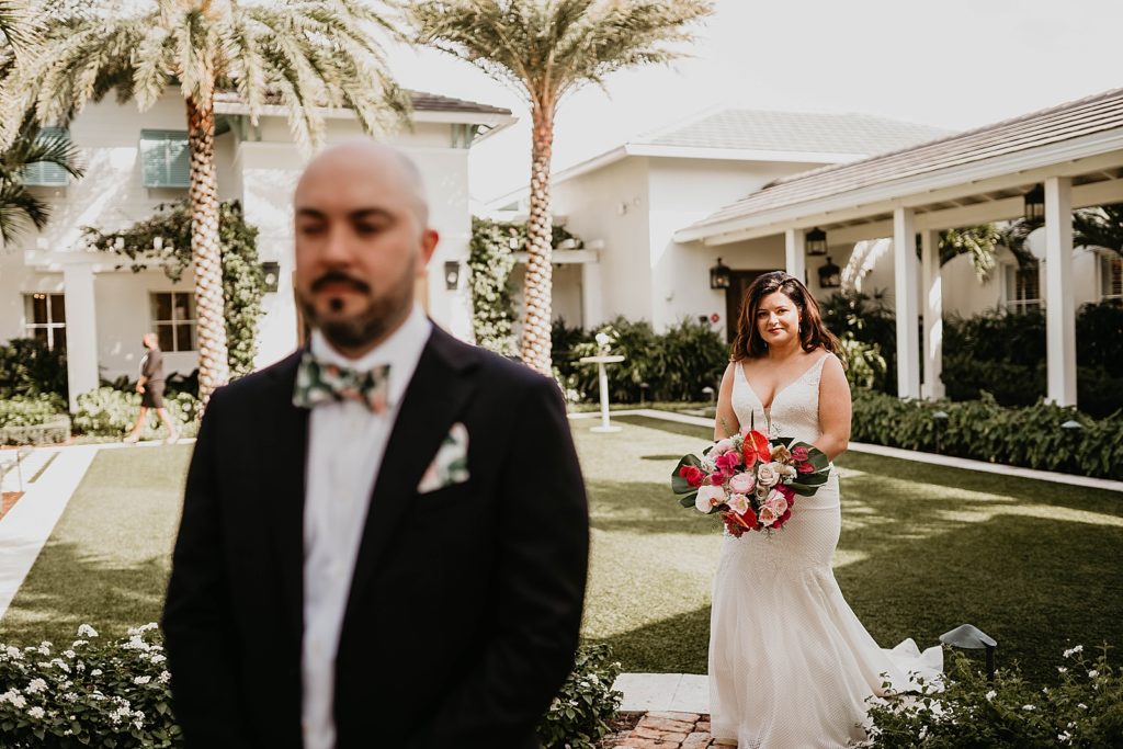 Bride approaching Groom with his back turned for first look Pelican Club Wedding Photography captured by South Florida Wedding Photographer Krystal Capone Photography 